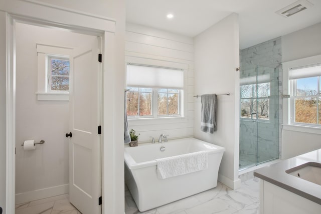 126 Mile Stretch Rd, Biddeford, ME 04005 - full bathroom with marble look tile flooring, vanity, a soaking tub, a shower stall, and recessed lighting
