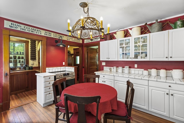 115 Babbidge Rd, Islesboro, ME 04848 - kitchen with white cabinetry, glass insert cabinets, light wood-style flooring, and crown molding