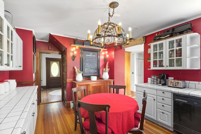 115 Babbidge Rd, Islesboro, ME 04848 - dining area with ornamental molding, a chandelier, and wood finished floors