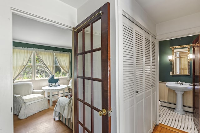 115 Babbidge Rd, Islesboro, ME 04848 - bathroom with a closet, wood finished floors, and a baseboard radiator