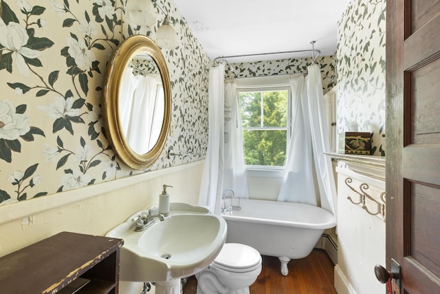 115 Babbidge Rd, Islesboro, ME 04848 - full bathroom with wallpapered walls, wood finished floors, a soaking tub, and a baseboard heating unit
