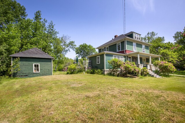 115 Babbidge Rd, Islesboro, ME 04848 - view of green lawn featuring covered porch
