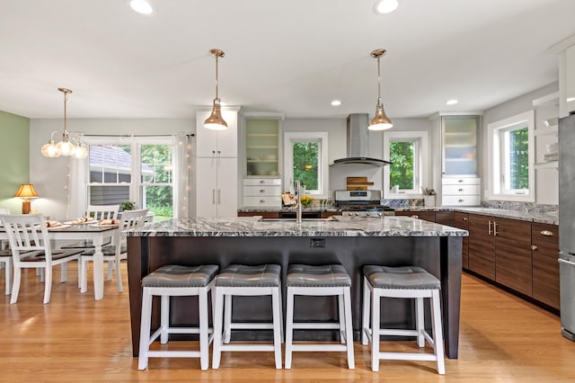 3 Ethan Way, Gray, ME 04039 - kitchen with wall chimney exhaust hood, a breakfast bar area, appliances with stainless steel finishes, healthy amount of natural light, and recessed lighting