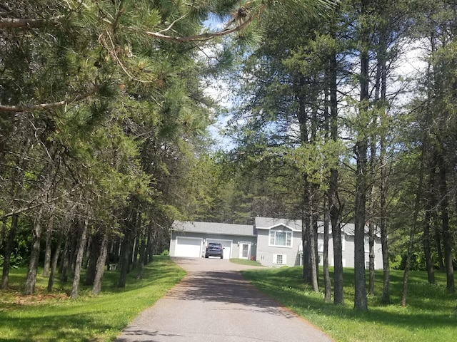 14 Reach Rd, Presque Isle, ME 04769 - tri-level home featuring driveway, a garage, and a front lawn