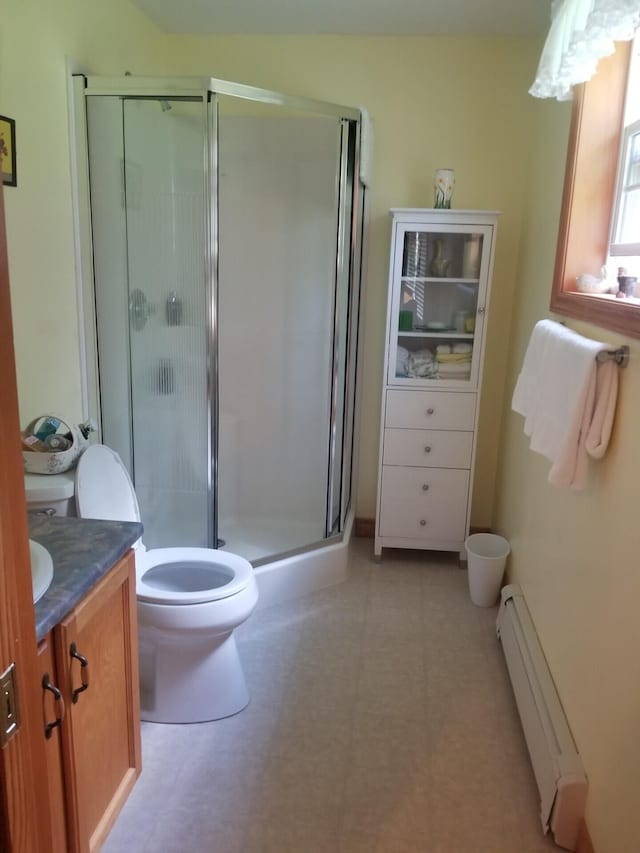 14 Reach Rd, Presque Isle, ME 04769 - bathroom with baseboard heating, vanity, a stall shower, and tile patterned floors