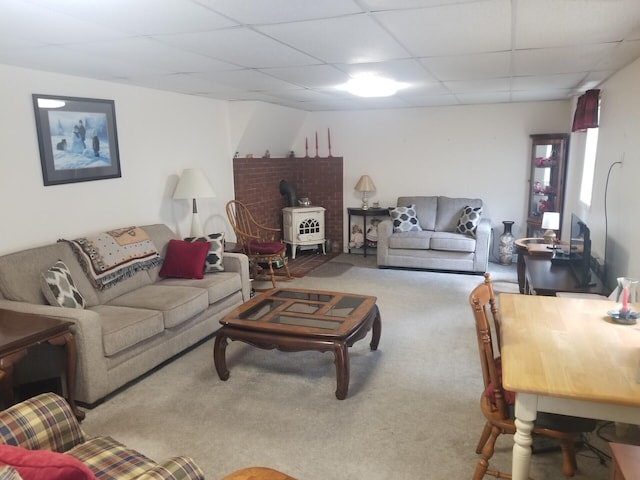 14 Reach Rd, Presque Isle, ME 04769 - carpeted living room featuring a wood stove and a paneled ceiling
