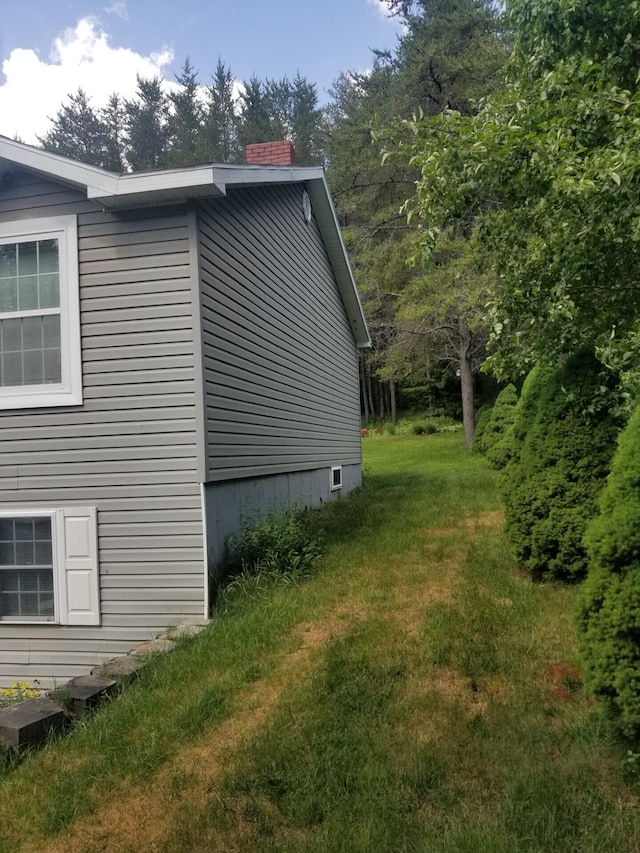 14 Reach Rd, Presque Isle, ME 04769 - view of side of property with a chimney and a yard