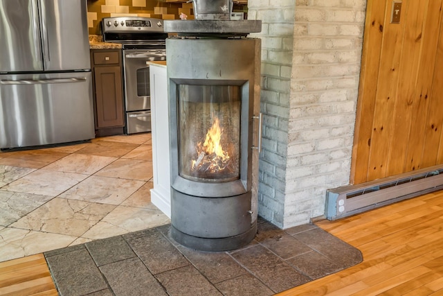 221 Gates Rd, Jefferson, ME 04348 - detailed view of stainless steel appliances, tile countertops, and a baseboard heating unit
