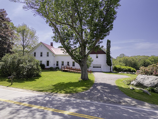 878 State Route 32, Bristol, ME 04564 - view of front of house with a garage, driveway, a front lawn, a chimney, and a metal roof
