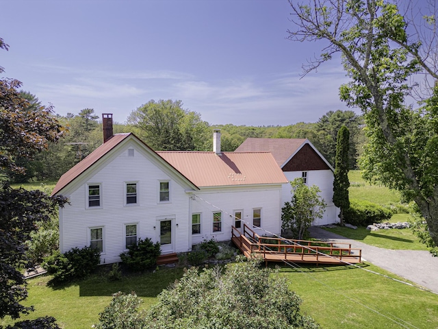 878 State Route 32, Bristol, ME 04564 - back of property with a lawn, a wooden deck, a chimney, and a metal roof