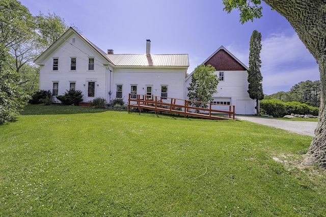 878 State Route 32, Bristol, ME 04564 - back of property with a chimney, a lawn, a metal roof, and a garage
