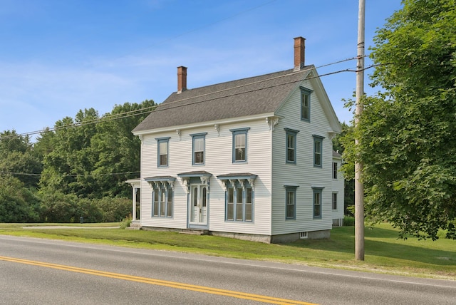 428 Webbs Mills Rd, Raymond, ME 04071 - view of front facade featuring a chimney, a front lawn, and roof with shingles