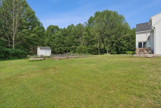 428 Webbs Mills Rd, Raymond, ME 04071 - view of yard with a storage unit, a wooden deck, and a forest view