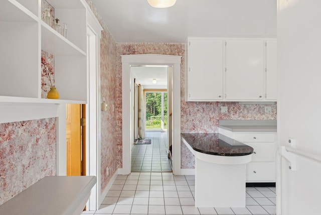 428 Webbs Mills Rd, Raymond, ME 04071 - kitchen with light tile patterned floors, white cabinets, and open shelves