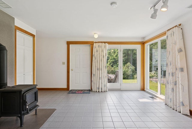 428 Webbs Mills Rd, Raymond, ME 04071 - unfurnished living room featuring a wood stove and light tile patterned floors