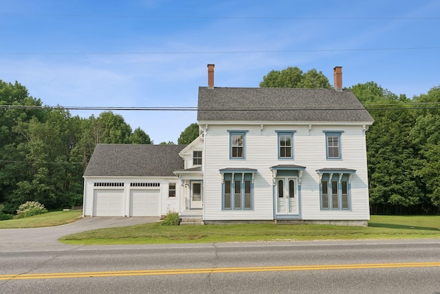 428 Webbs Mills Rd, Raymond, ME 04071 - view of front of home with a chimney, asphalt driveway, a garage, and a front lawn