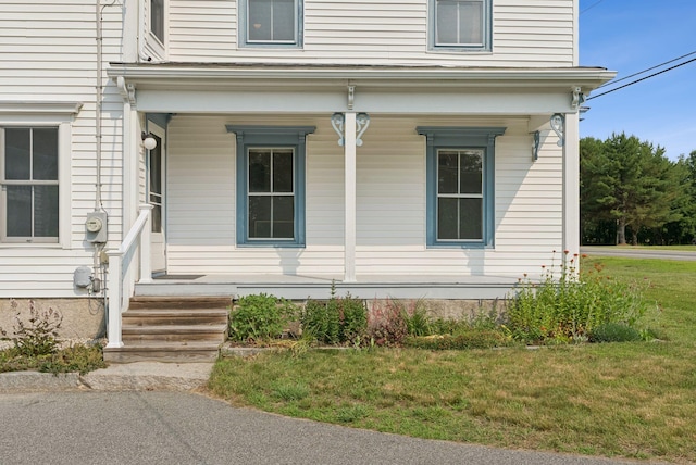 428 Webbs Mills Rd, Raymond, ME 04071 - view of exterior entry with a porch and a yard