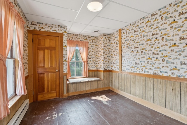 428 Webbs Mills Rd, Raymond, ME 04071 - spare room with a baseboard heating unit, wallpapered walls, wainscoting, hardwood / wood-style floors, and a drop ceiling