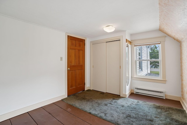 428 Webbs Mills Rd, Raymond, ME 04071 - unfurnished bedroom with a baseboard radiator, a closet, and wood finished floors