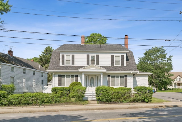 930 Forest Ave, Portland, ME 04103 - colonial inspired home featuring a gambrel roof, a shingled roof, and a chimney