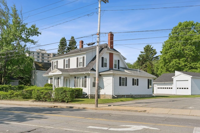 930 Forest Ave, Portland, ME 04103 - view of front of property with a chimney, an outdoor structure, a detached garage, and a shingled roof