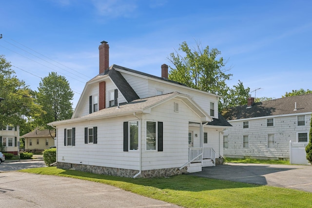 930 Forest Ave, Portland, ME 04103 - view of front facade with a chimney, a shingled roof, and a front yard