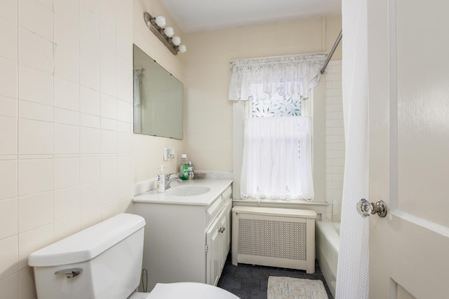 930 Forest Ave, Portland, ME 04103 - bathroom featuring radiator, vanity, shower / tub combo with curtain, and tile walls