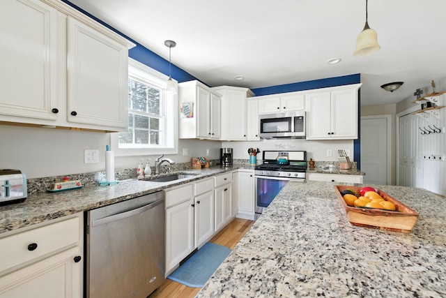 50 Carlisle Ln, Wells, ME 04090 - kitchen with stainless steel appliances, light wood finished floors, light stone counters, white cabinets, and recessed lighting