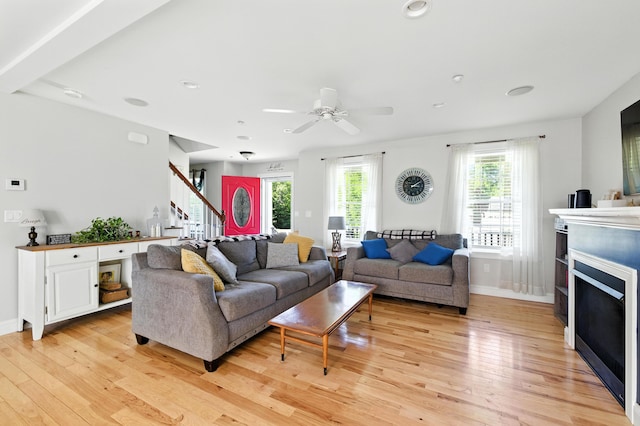 50 Carlisle Ln, Wells, ME 04090 - living area featuring light wood finished floors, stairs, a fireplace, and ceiling fan