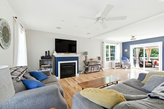 50 Carlisle Ln, Wells, ME 04090 - living area featuring light wood-style floors, a fireplace, and a ceiling fan