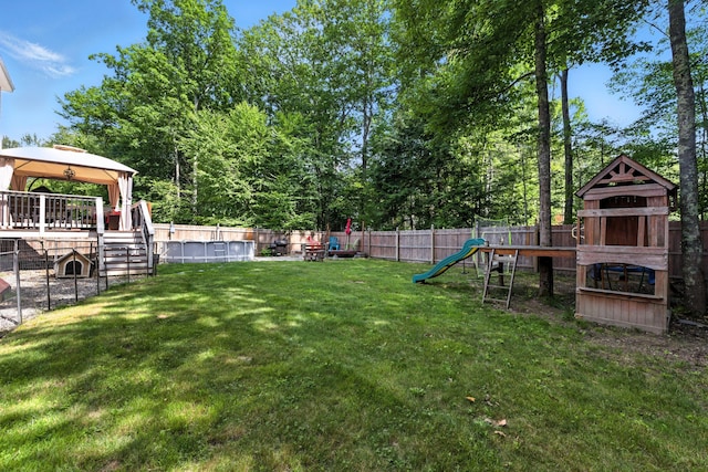 50 Carlisle Ln, Wells, ME 04090 - fenced backyard with a playground, a gazebo, and view of wooded area