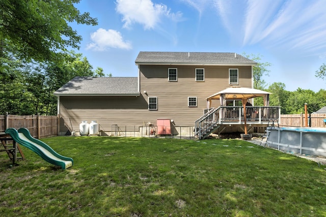 50 Carlisle Ln, Wells, ME 04090 - back of house with a gazebo, a fenced backyard, a playground, and roof with shingles