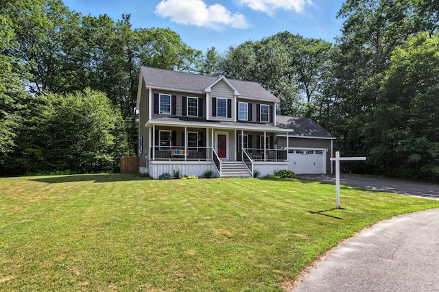 50 Carlisle Ln, Wells, ME 04090 - colonial-style house with covered porch, driveway, a front lawn, and an attached garage