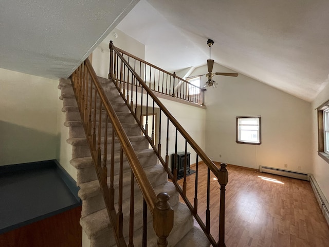 29 Range Rd, Brunswick, ME 04011 - stairway featuring a baseboard radiator, a ceiling fan, wood finished floors, and lofted ceiling