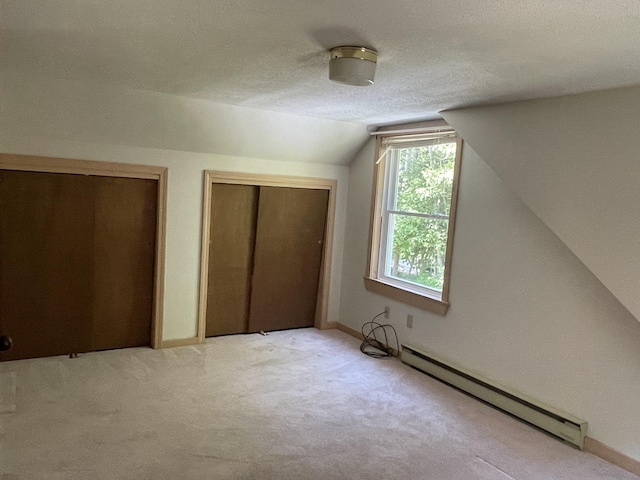 29 Range Rd, Brunswick, ME 04011 - additional living space with baseboard heating, vaulted ceiling, light colored carpet, and a textured ceiling