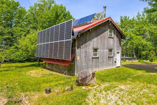 22 Woodpecker Ln, Embden, ME 04958 - view of property exterior with solar panels and a metal roof