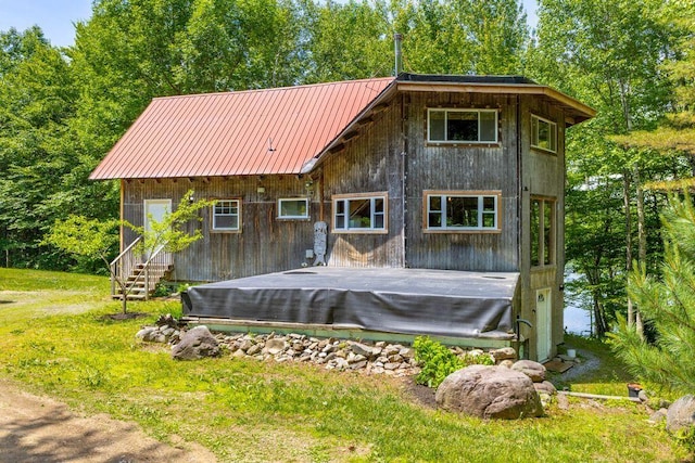 22 Woodpecker Ln, Embden, ME 04958 - rear view of property with a deck, a metal roof, and a yard