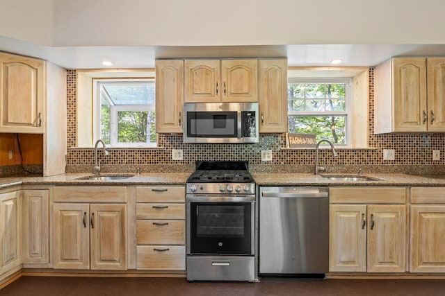 22 Woodpecker Ln, Embden, ME 04958 - kitchen featuring appliances with stainless steel finishes, light brown cabinets, decorative backsplash, and plenty of natural light