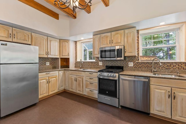 22 Woodpecker Ln, Embden, ME 04958 - kitchen featuring stainless steel appliances, light brown cabinetry, dark stone counters, tasteful backsplash, and beam ceiling