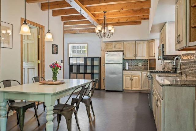 22 Woodpecker Ln, Embden, ME 04958 - kitchen featuring freestanding refrigerator, beam ceiling, tasteful backsplash, a chandelier, and dark stone countertops