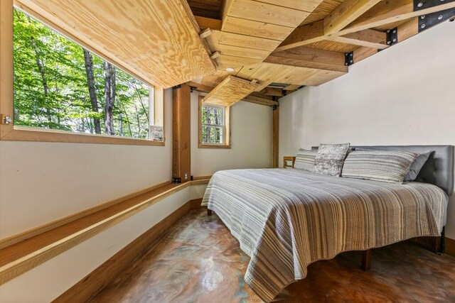 22 Woodpecker Ln, Embden, ME 04958 - bedroom featuring wooden ceiling and finished concrete floors