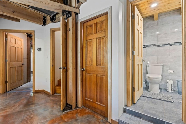 22 Woodpecker Ln, Embden, ME 04958 - bathroom with tile walls, recessed lighting, and concrete flooring