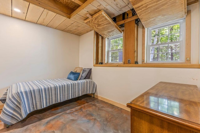 22 Woodpecker Ln, Embden, ME 04958 - bedroom featuring wooden ceiling and finished concrete floors