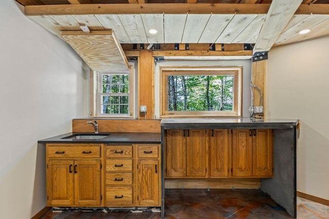 22 Woodpecker Ln, Embden, ME 04958 - kitchen with brown cabinetry, dark countertops, wooden ceiling, and recessed lighting