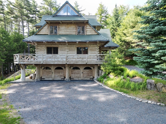 378 Black Point Rd, Beaver Cove, ME 04441 - view of front of property with a carport, asphalt driveway, and stone siding