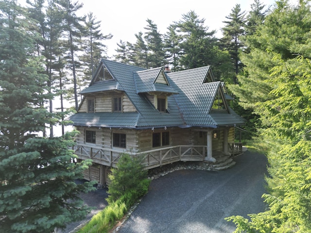 378 Black Point Rd, Beaver Cove, ME 04441 - view of front of property featuring a porch, a chimney, and driveway