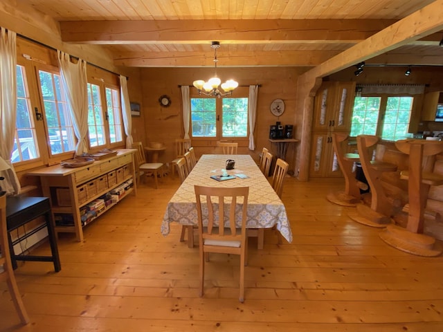 378 Black Point Rd, Beaver Cove, ME 04441 - dining room featuring a wood ceiling with exposed beams, light wood-type flooring, healthy amount of natural light, and a chandelier