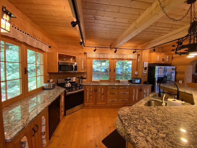 378 Black Point Rd, Beaver Cove, ME 04441 - kitchen featuring stainless steel appliances, a wooden ceiling with exposed beams, rail lighting, light wood-type flooring, and brown cabinets