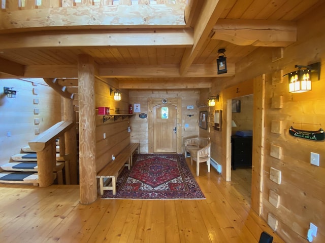 378 Black Point Rd, Beaver Cove, ME 04441 - entryway featuring wooden walls, light wood-type flooring, and a wood ceiling with exposed beams