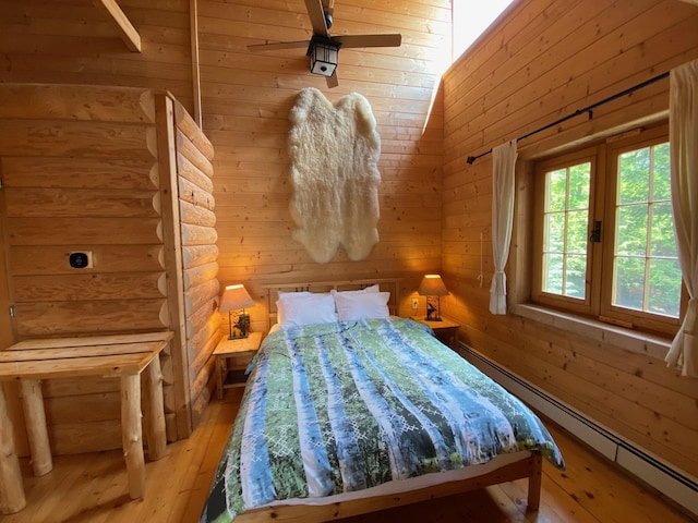378 Black Point Rd, Beaver Cove, ME 04441 - bedroom featuring a baseboard heating unit and light wood finished floors